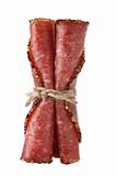 three pieces slices german pepper salami sausage tied by rope