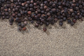 black peppers whole and ground on background
