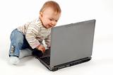 baby having fun with laptop