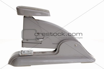 Vintage grey stapler, side view. 