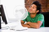 Office working with electric fan
