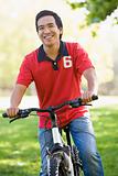 Asian man riding bike in the park