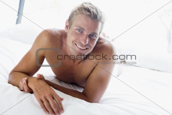 Young man relaxing in bed