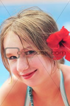 Portrait of a girl with red flower
