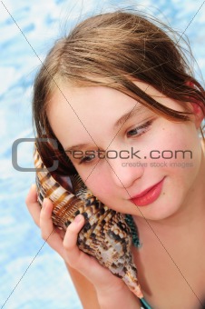 Young girl with seashell