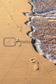 Tropical beach with footprints