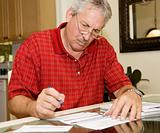 Mature Man Signing Papers
