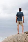 Man standing on a rock at the sea