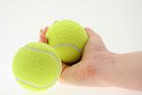 hand with two tennis balls