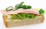 tasty ham sandwich with lettuce and chive on white bread