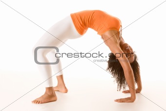 Tanned female in sport clothes performing bridge exercise 