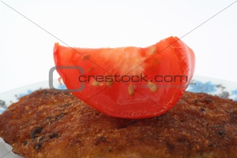 macro of steak with tomato on a plate