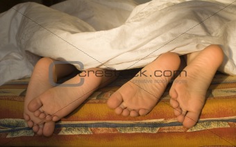 feet of sisters in bad - morning