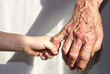 hand of grandmother and grandchild