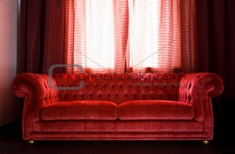 Drawing room with a red sofa