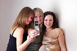 three attractive young women photographed by phone