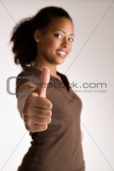 Woman is holding her thumb up