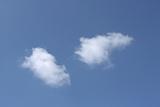 two white fluffy clouds in blue sky