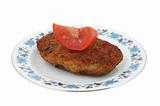 steak with tomato on a patterned plate