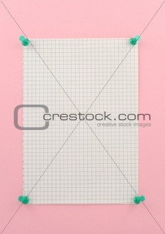 piece of squared paper pinned to pink wall