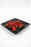 strawberries on Black Plate over White 