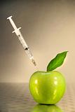 Close-up of syringe in green apple