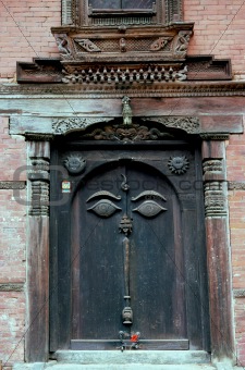 Nepalese carved wooden doorway with Buddha’s eyes