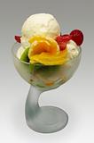 white ice cream decorated with fresh fruits, isolated on gray