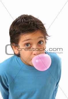 Boy blowing a pink bubble gum