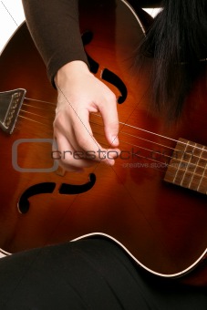 Playing strumming a guitar