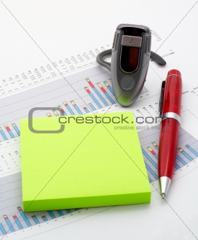 Handsfree, notes and pen on earnings chart background