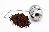 Tea and stainless steel tea ball on white background