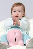 Child Holding Piggy Bank and Claping Hands