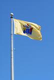 New Jersey state flag against blue sky