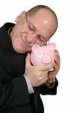 Business Man Hugging Piggy Bank 