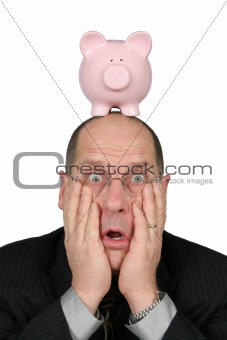 Business Man with Piggy Bank on head and hands on face