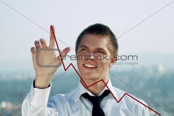 young man pointing to the top of a chart