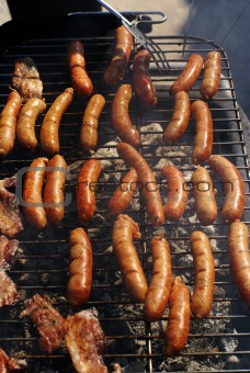 making nice juicy sausages on grill