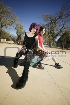 Two Punk Girls Sitting on Suitcases