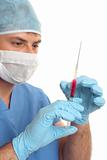 Surgeon preparing checking needle syringe