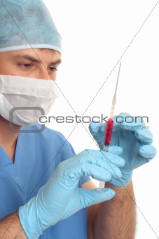 Surgeon preparing checking needle syringe