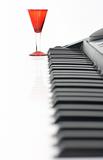 Piano keyboard and red glass