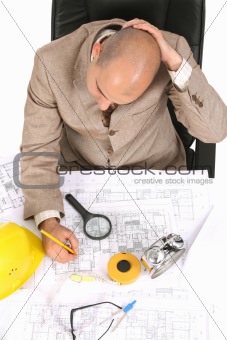 Businessman thinking with architectural plans