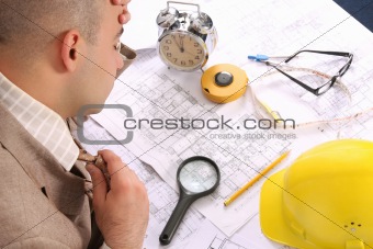 A businessman sleepy with architectural plans