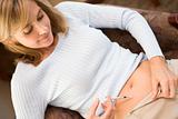 Woman injecting drugs to prepare for IVF treatment