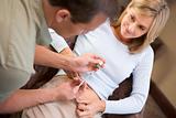 Man helping woman inject drugs to prepare for IVF treatment