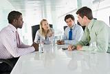 Four businesspeople having meeting around table