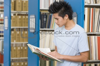 University student reading in library