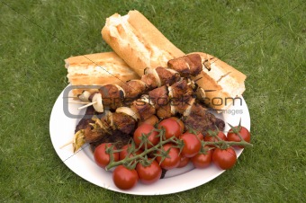 grilled barbecue meat and bread and tomatoes