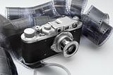 Vintage rangefinder camera in black and white film rolls